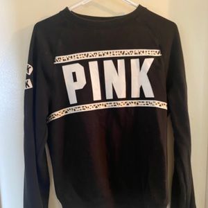 Pink crew neck sweatshirt.